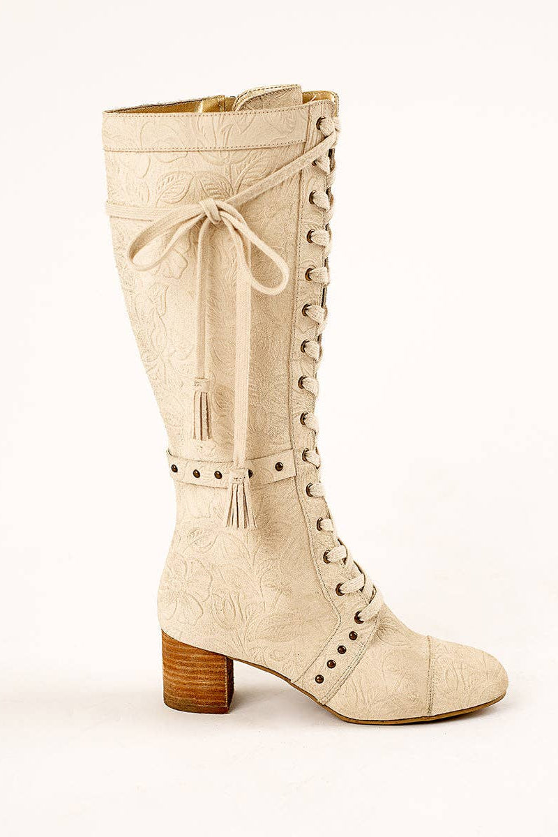 Beige knee-high boot with lace-up design on a white background