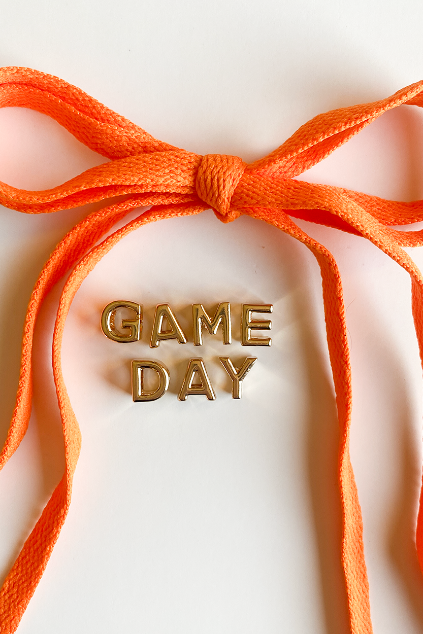 Orange ribbon with 'GAME DAY' text on a white background