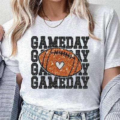 Person wearing a 'GAMEDAY' t-shirt with a football graphic on a plain background