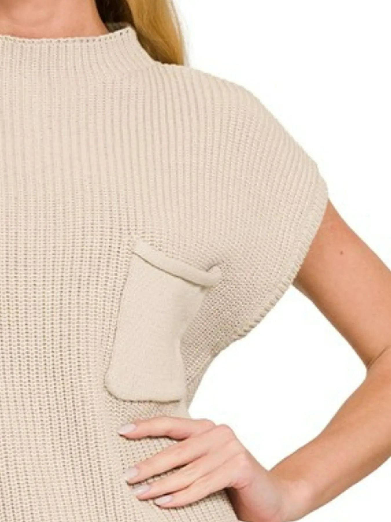 Beige knit top with a pocket on a white background