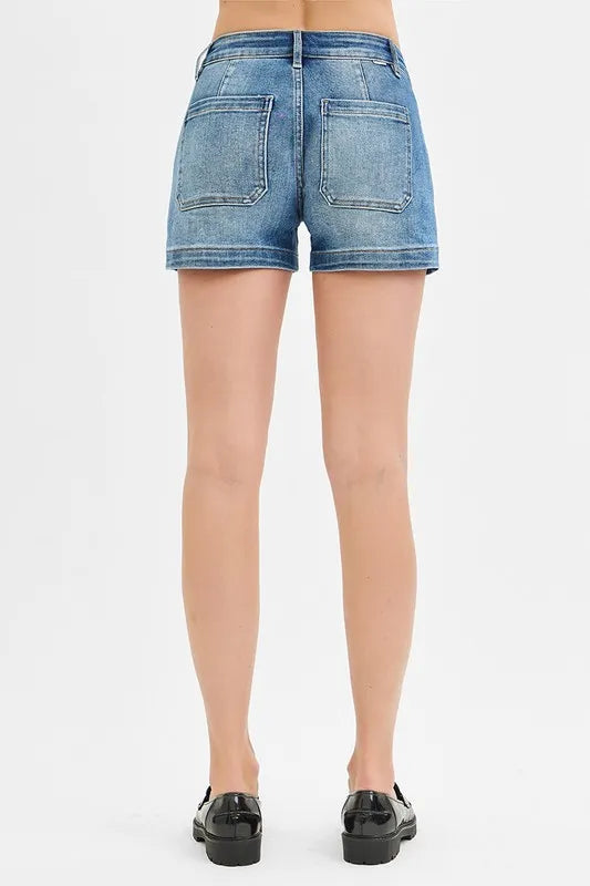 Denim shorts worn by a person on a white background