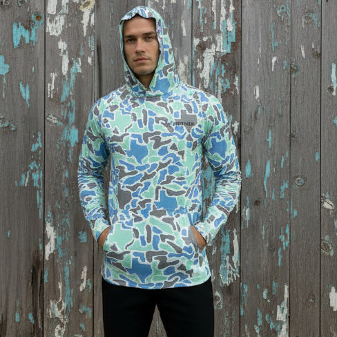 Camouflage-patterned hoodie on a mannequin against a white background