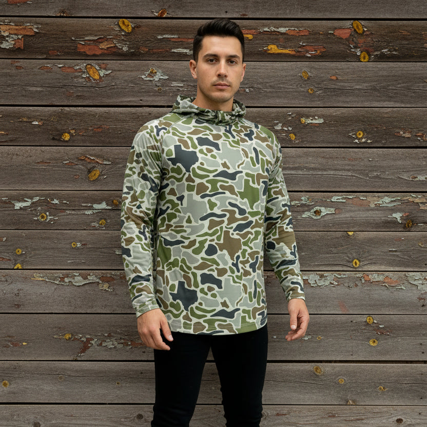 Camouflage-patterned raincoat on a mannequin against a white wall.