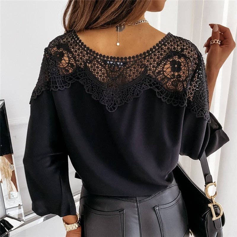 Black blouse with lace detailing worn by a person, with a blurred background.