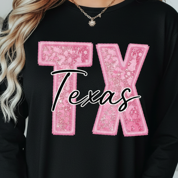 Person wearing a black t-shirt with pink 'TX Texas' design.