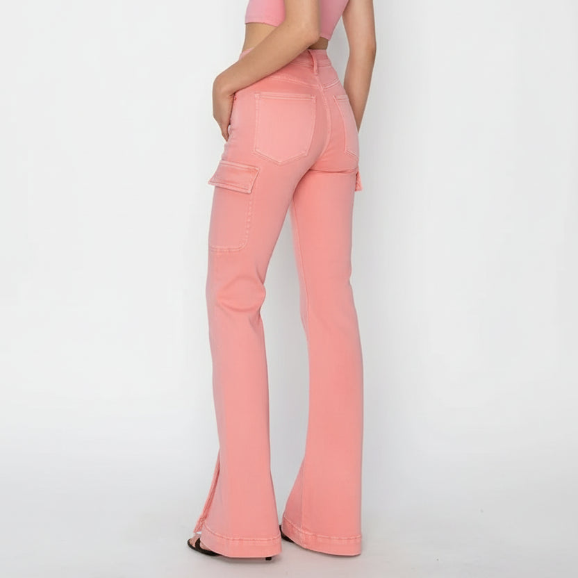 Person wearing pink flared jeans on a white background