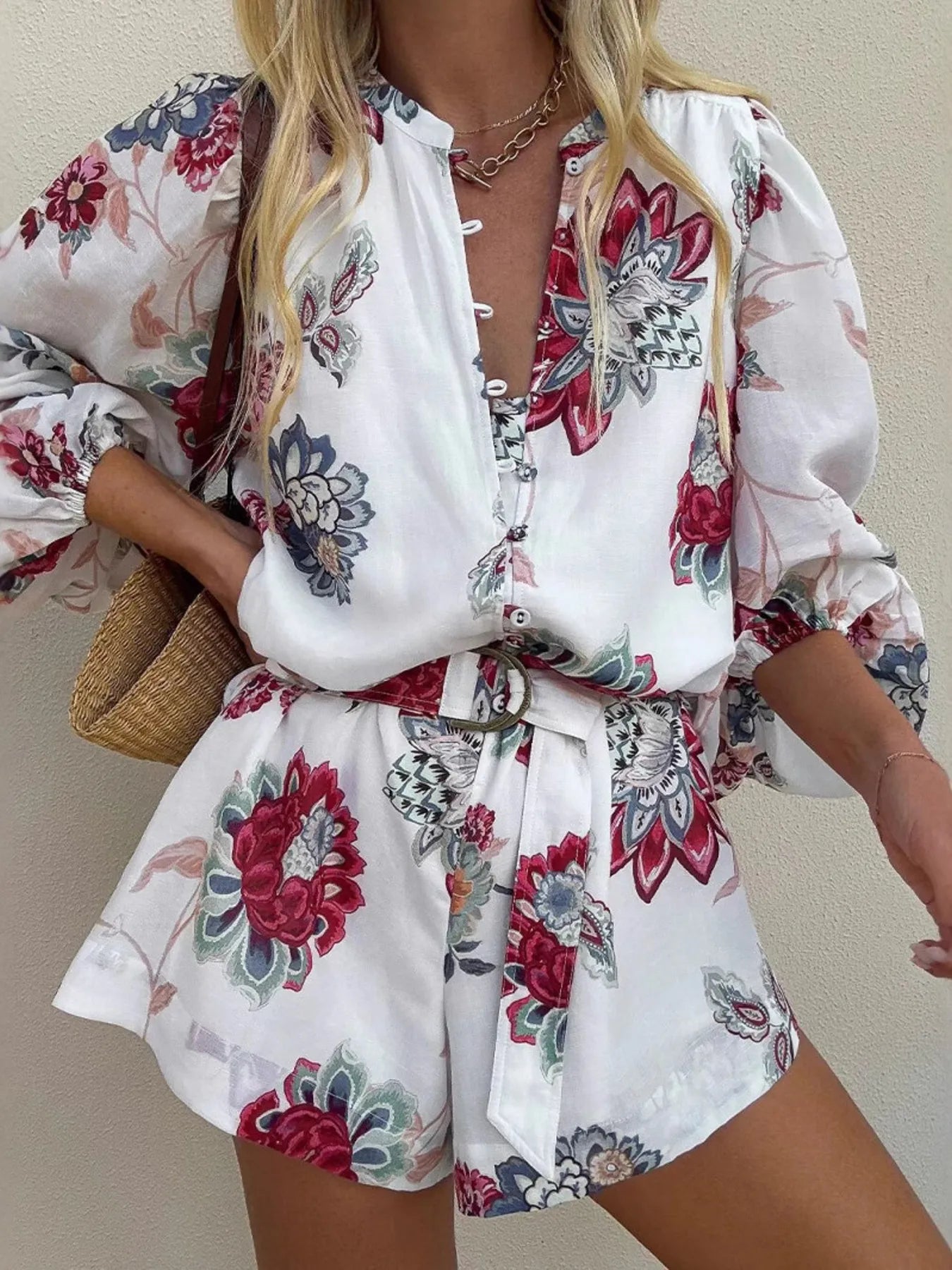 Woman wearing a floral romper with a plain background