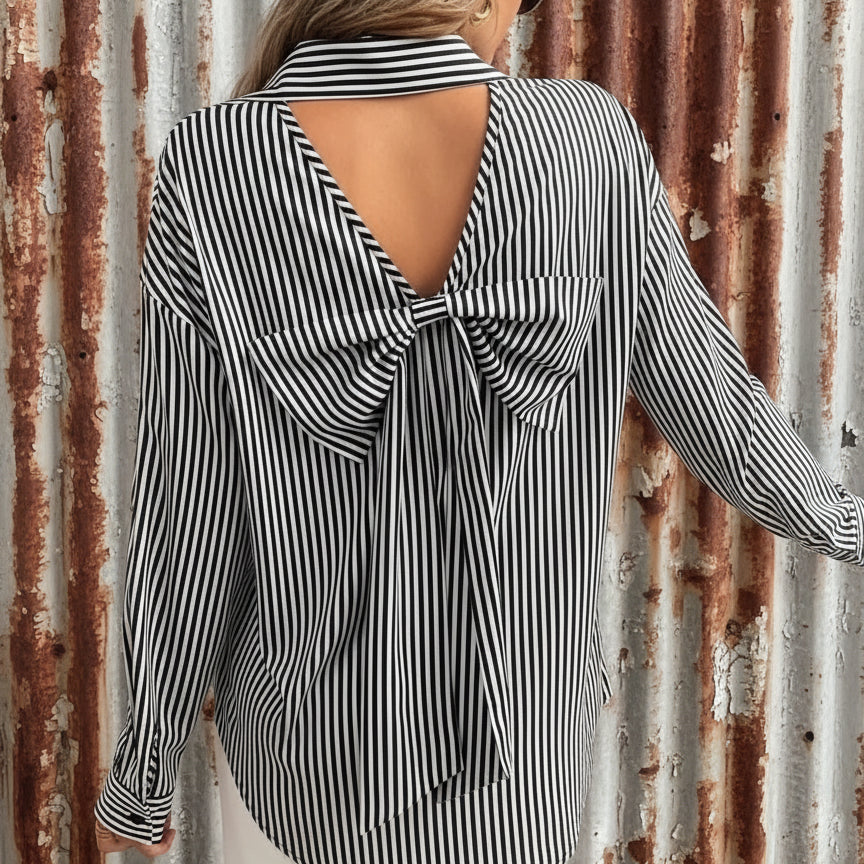 Black and white striped blouse with open back worn by a person indoors.