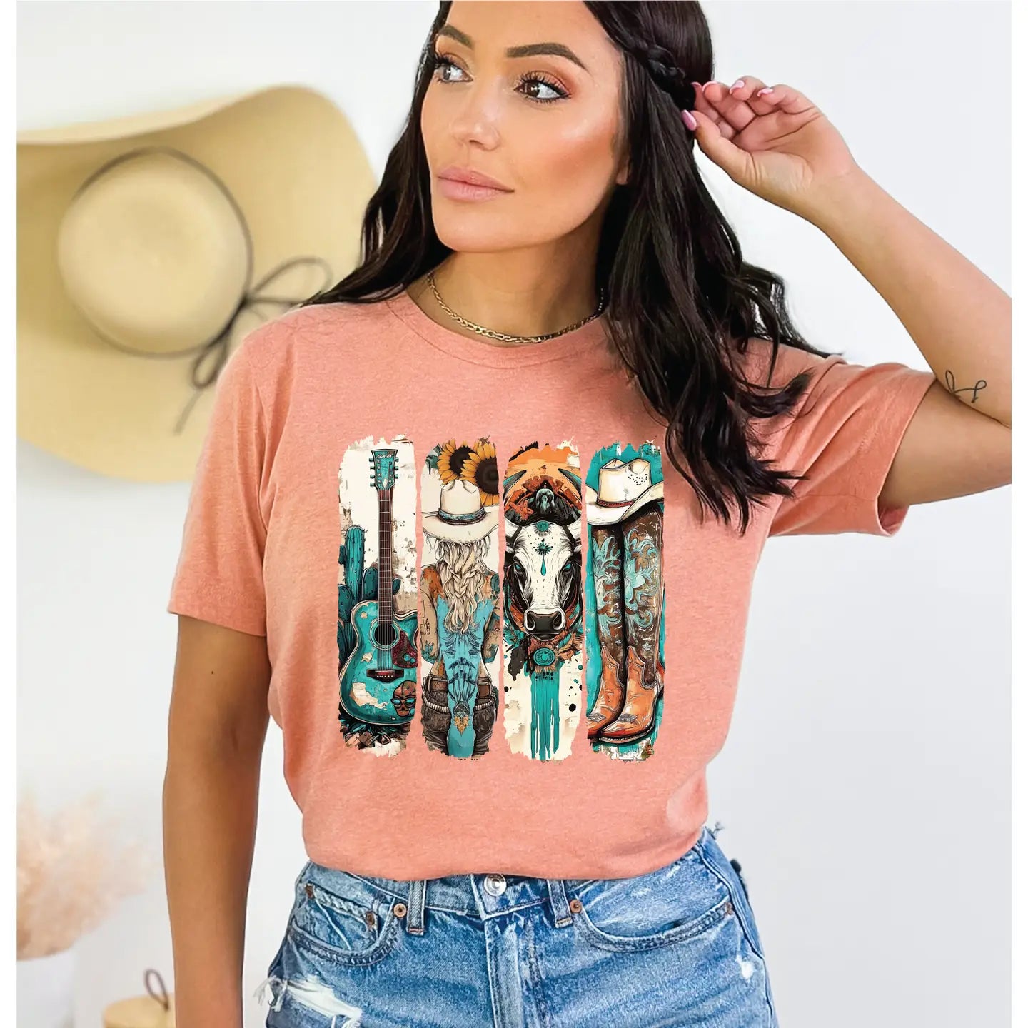 Woman wearing a pink t-shirt with a graphic design of a cow, guitar, and boots.