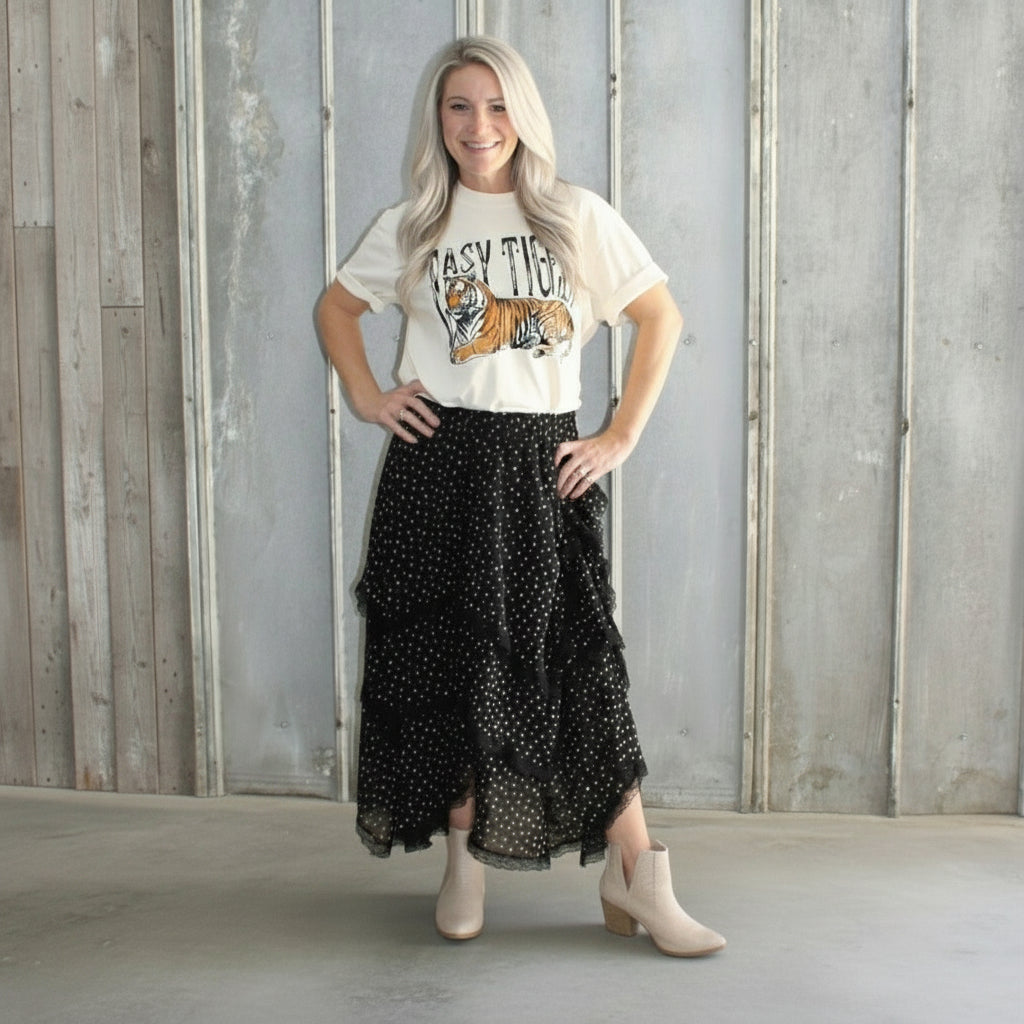 Person standing in front of a metal door with a textured wall.