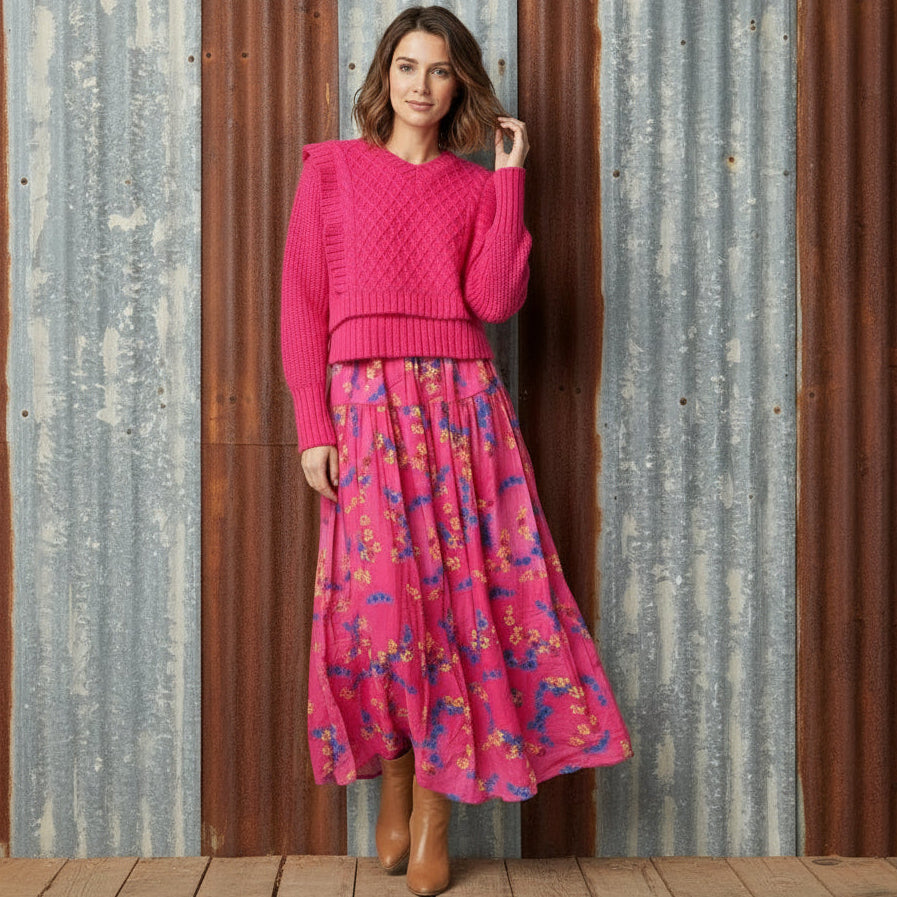 Pink dress with floral pattern on a wooden floor