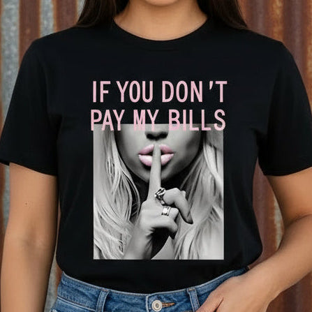 Person wearing a black t-shirt with a graphic and text, standing in a room.