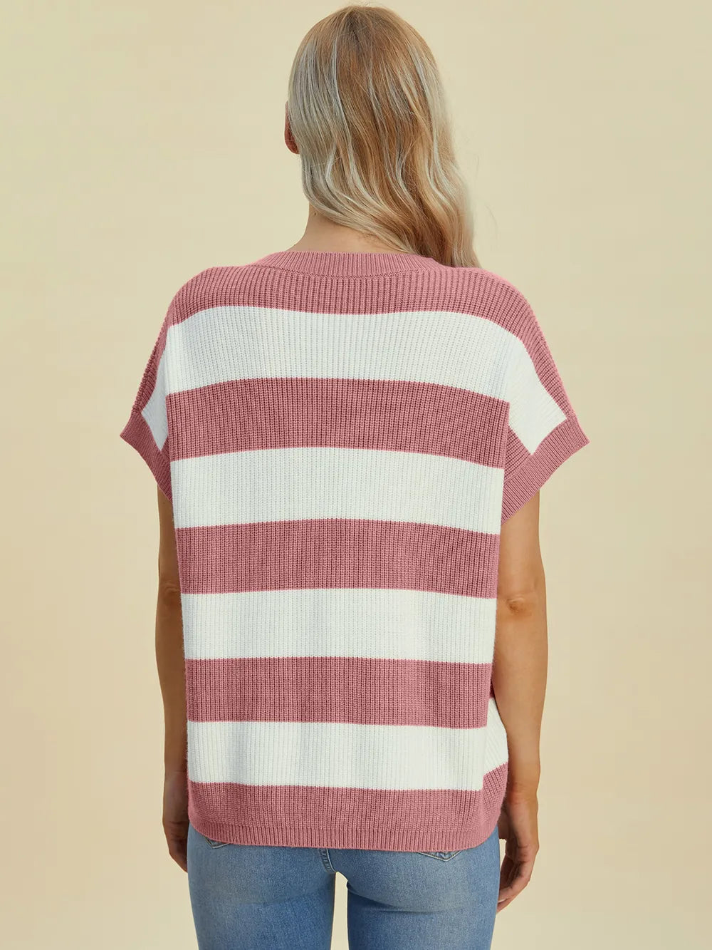 Person wearing a red and white striped shirt on a beige background