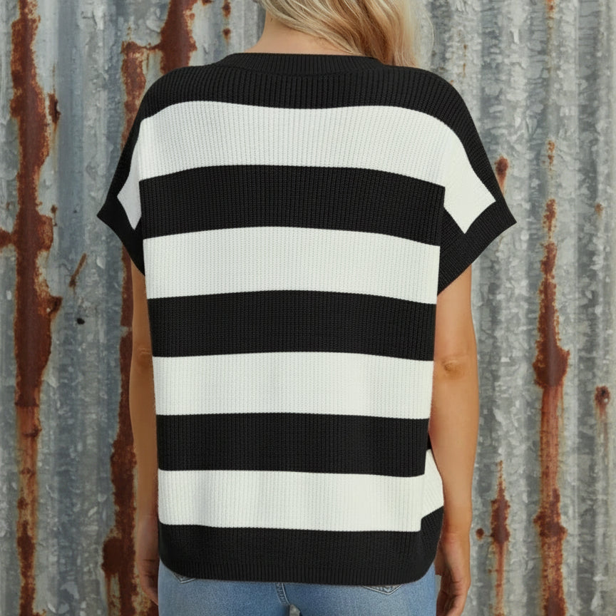 Black and white striped shirt worn by a person on a beige background