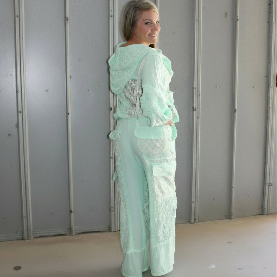 Person lying on a set of wooden stairs with a concrete wall in the background