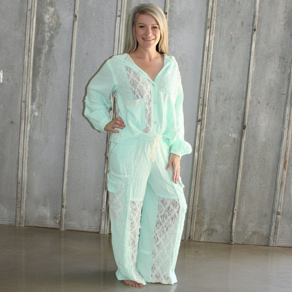 Person lying on a wooden floor with a light blue dress.