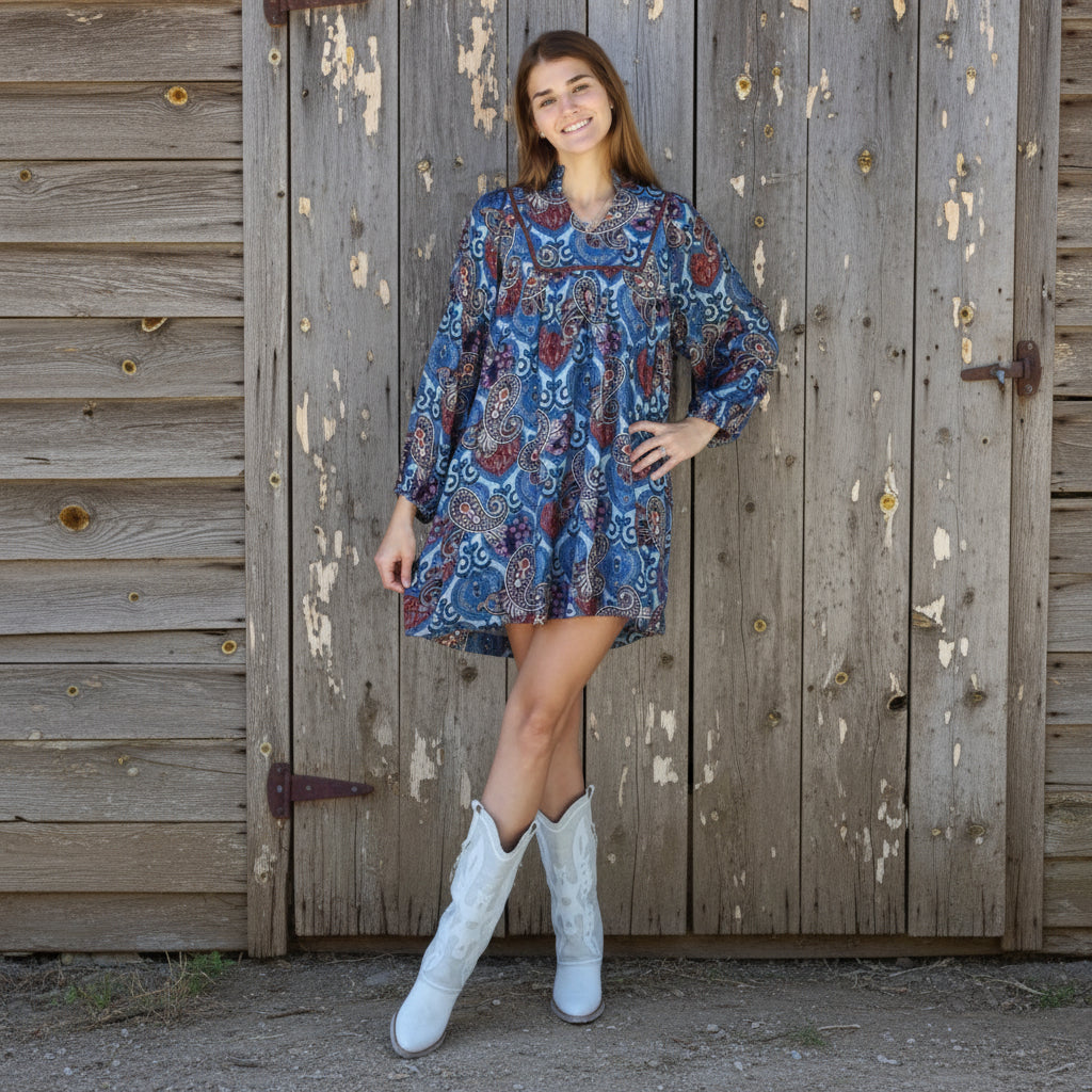 Person standing on a brick pavement with a neutral background