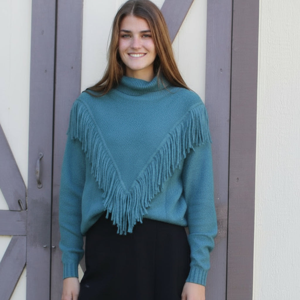 Woman standing on a small wooden platform in front of a white building with a gray door.