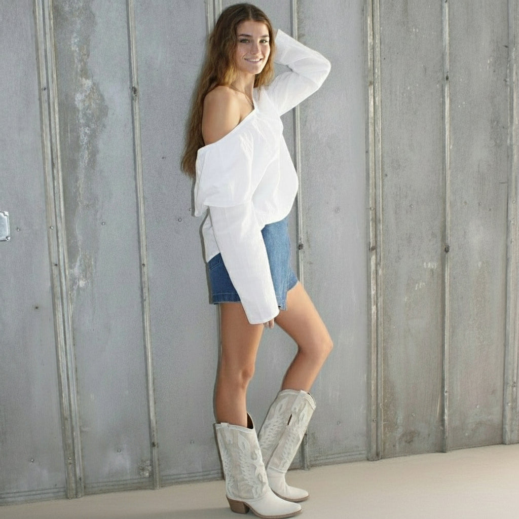 Woman lying on a wooden staircase against a wall