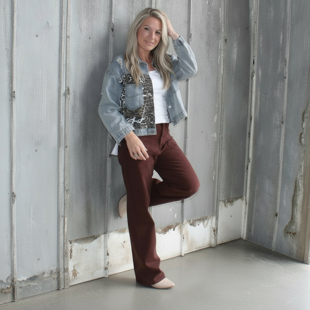 Person standing in front of a wooden building