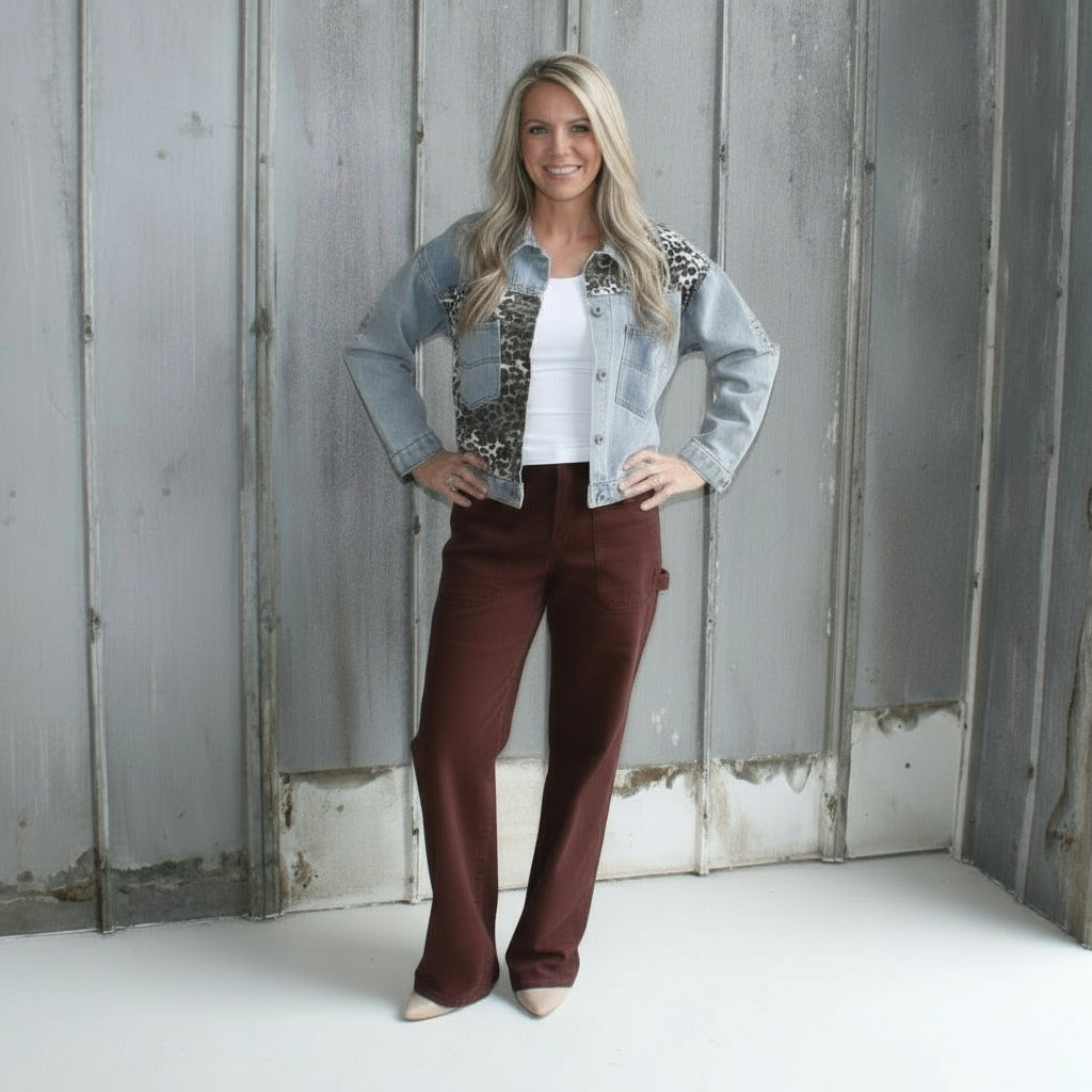 Woman standing in front of a rustic wooden building
