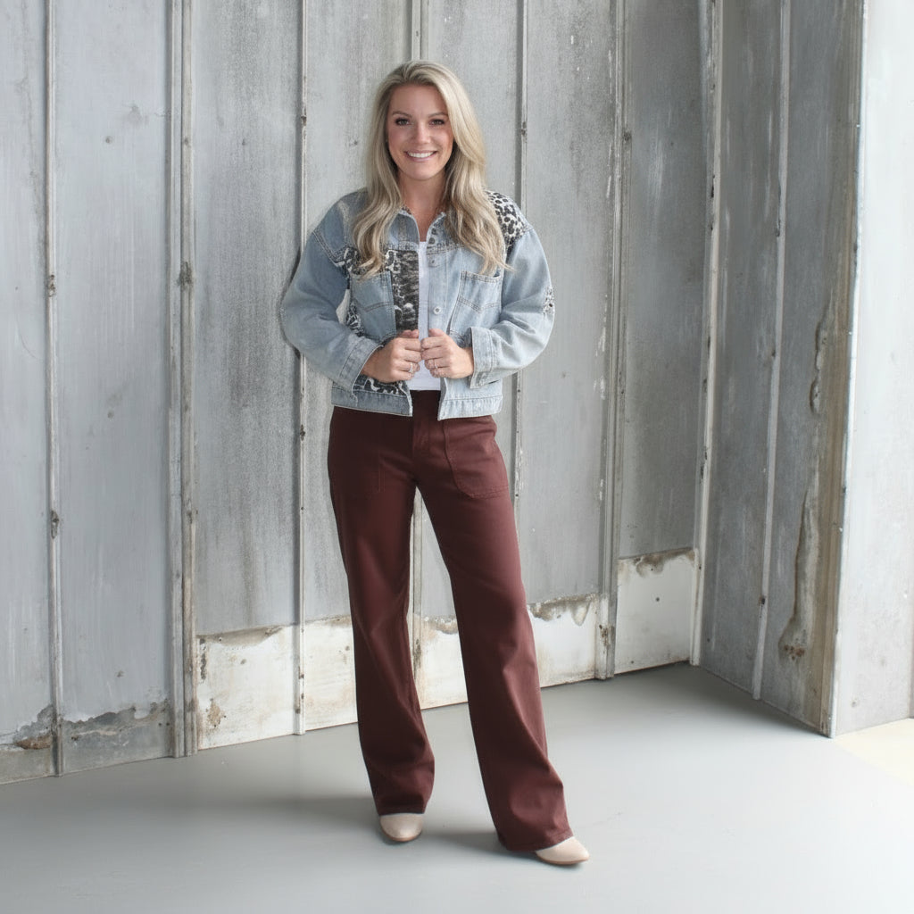 Person standing on a set of stairs with a wooden deck and stone wall in the background