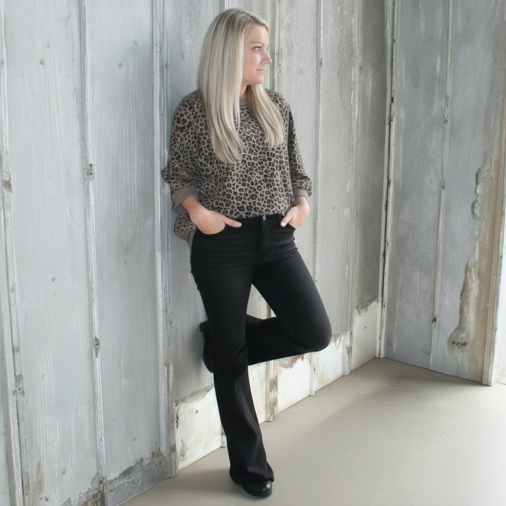 Person sitting on a set of wooden stairs outdoors
