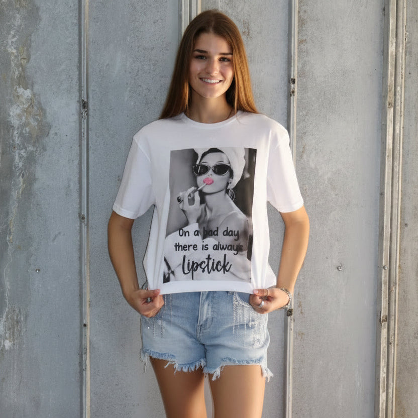 Woman lying on a concrete floor holding a magazine