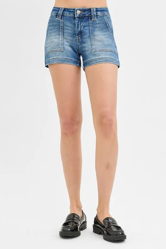 Denim shorts worn by a person on a white background
