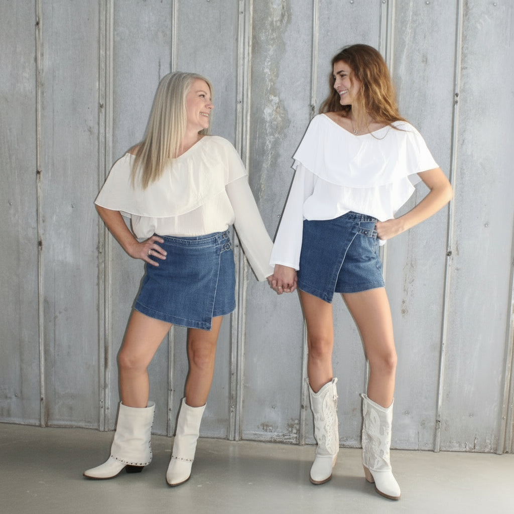 Two people in matching outfits standing on a set of stairs.