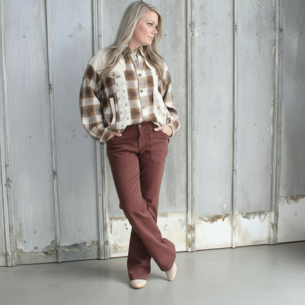 Person standing on a set of stairs with a textured wall and floor.
