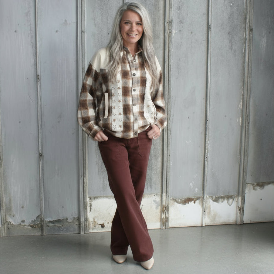 Person standing on a set of stairs with a textured wall and floor in the background