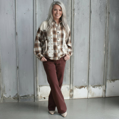 Person standing on a set of stairs with a textured wall and floor in the background
