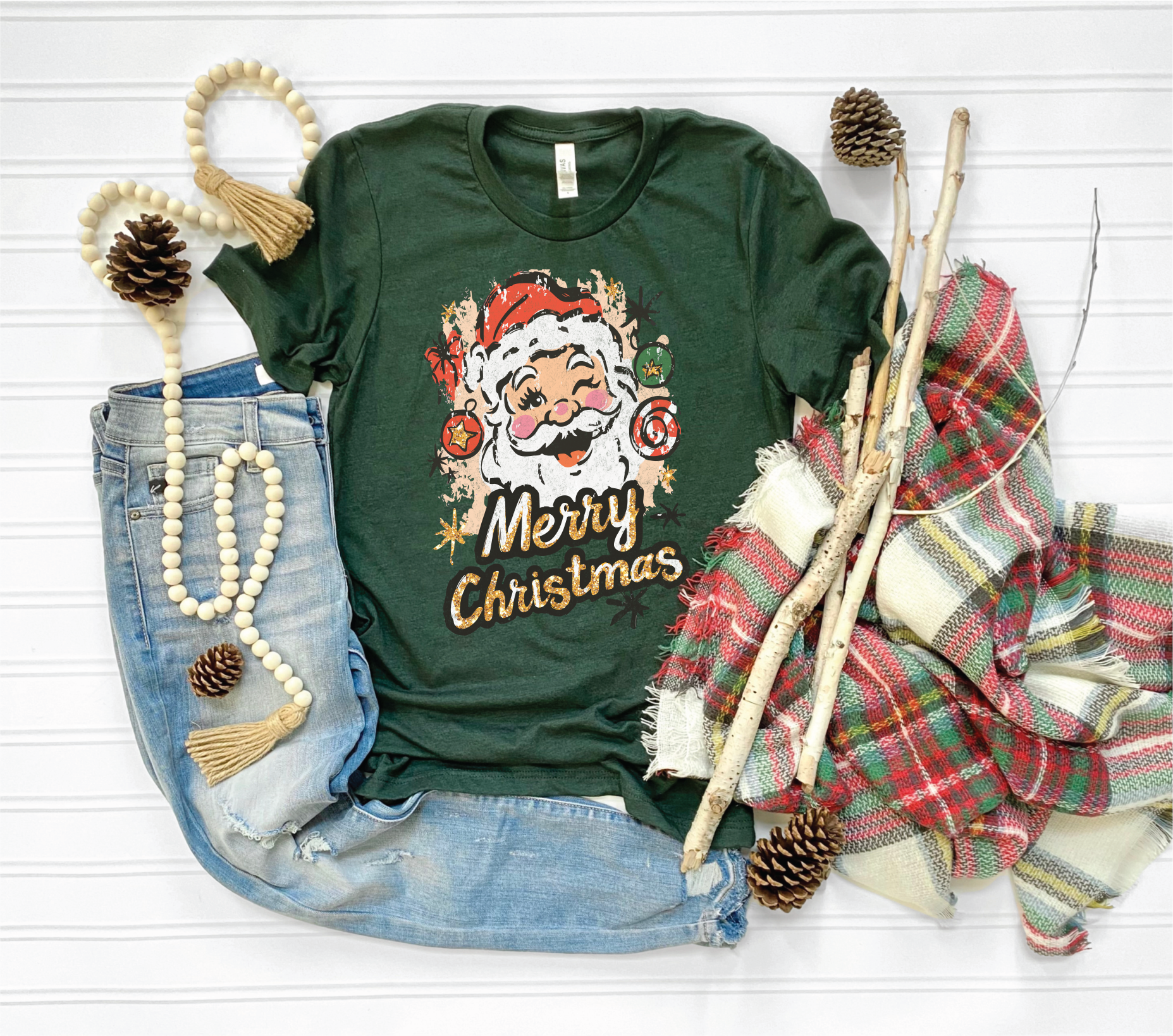 Green t-shirt with Santa Claus design and 'Merry Christmas' text, surrounded by festive items on a white background.