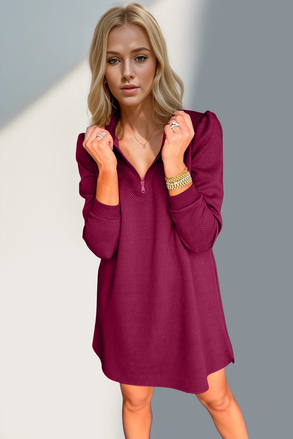 Woman wearing a burgundy dress with a plain background