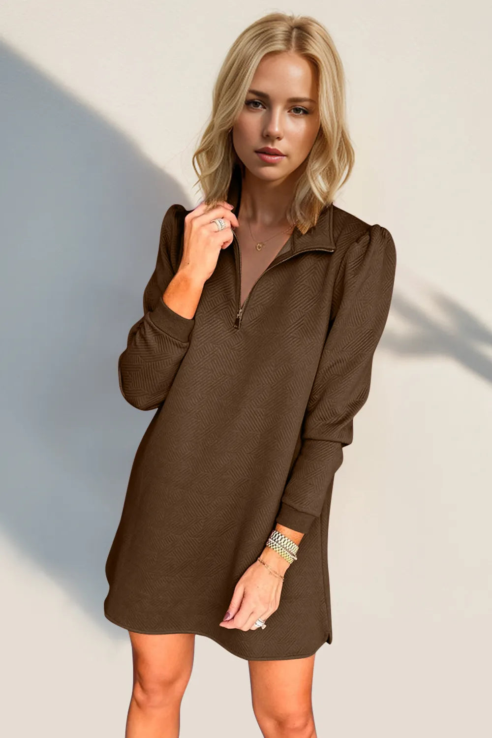 Woman wearing a brown dress against a light background