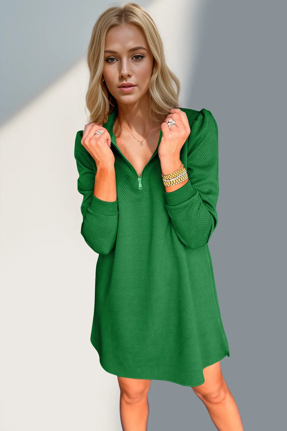 Woman wearing a green dress against a gray background