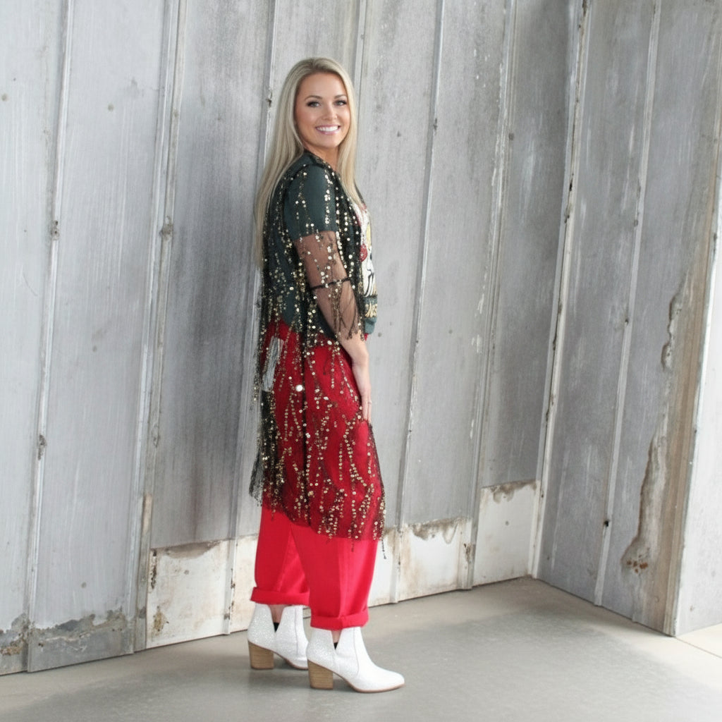 Person standing on a wooden deck wearing a black and red outfit.