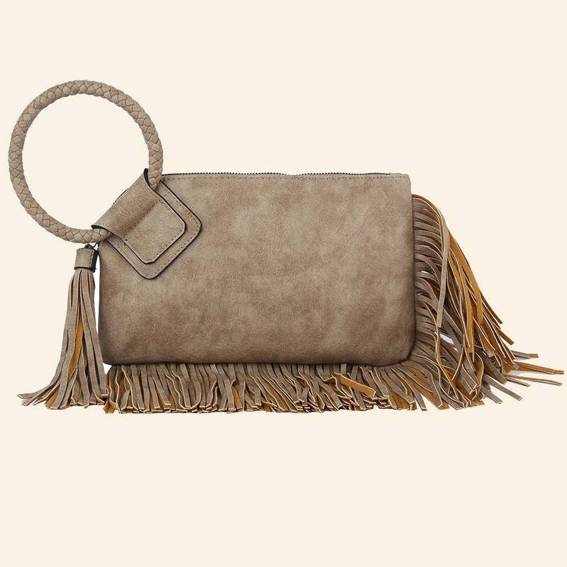 Gray suede handbag with tassels on a beige background