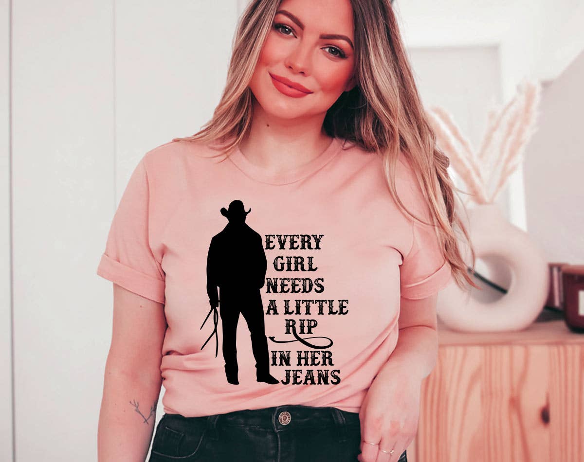 Woman wearing a pink t-shirt with a graphic and text, sitting indoors.