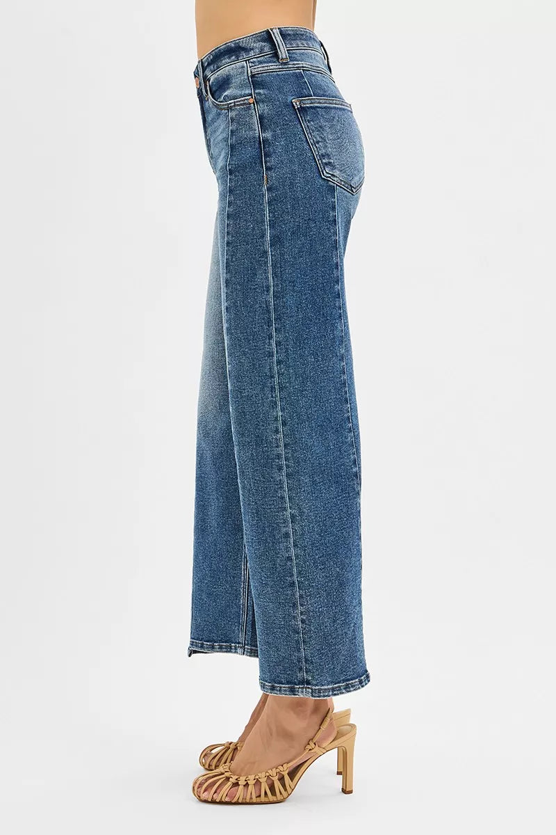 Blue jeans worn by a person on a white background