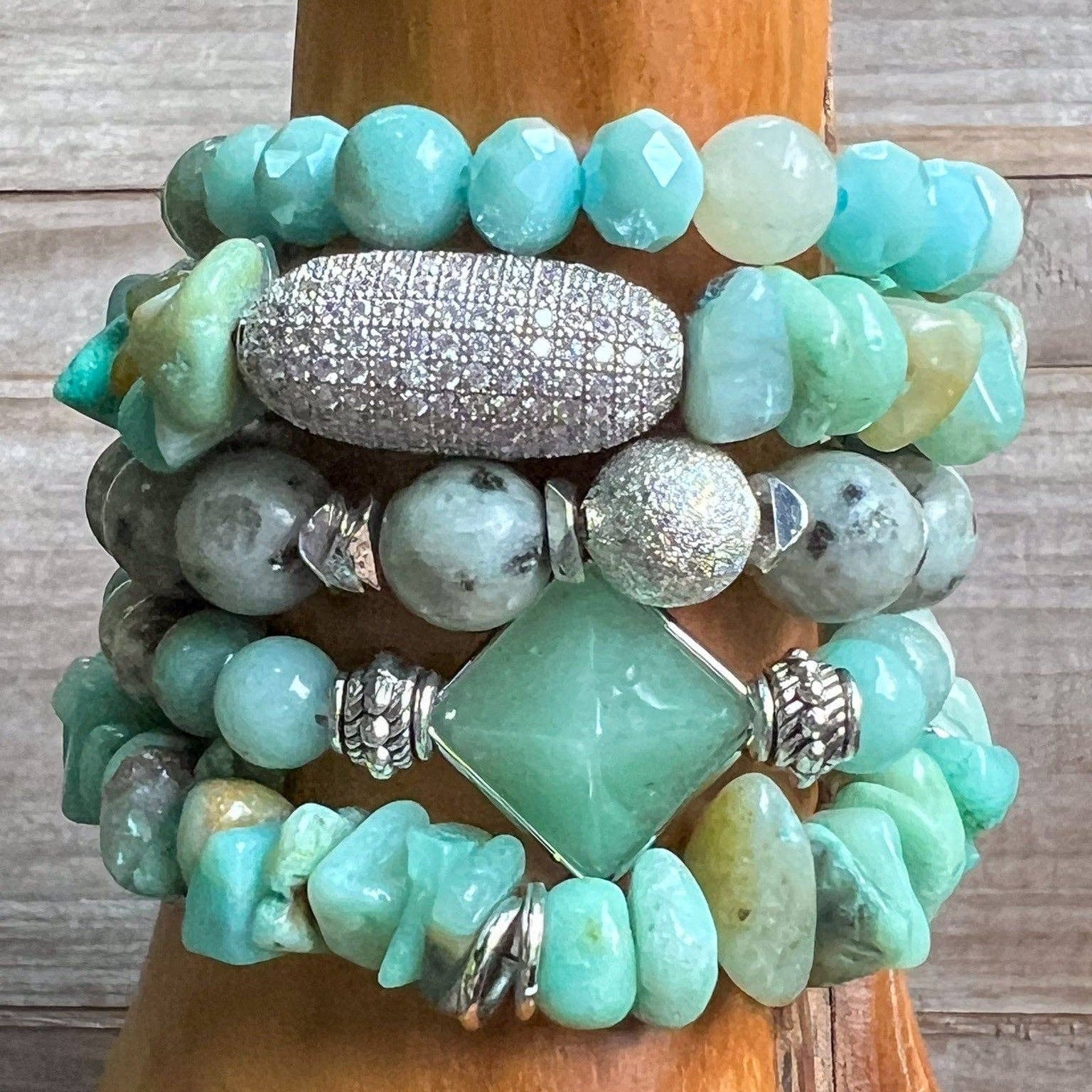 Stack of turquoise beaded bracelets on a wooden surface