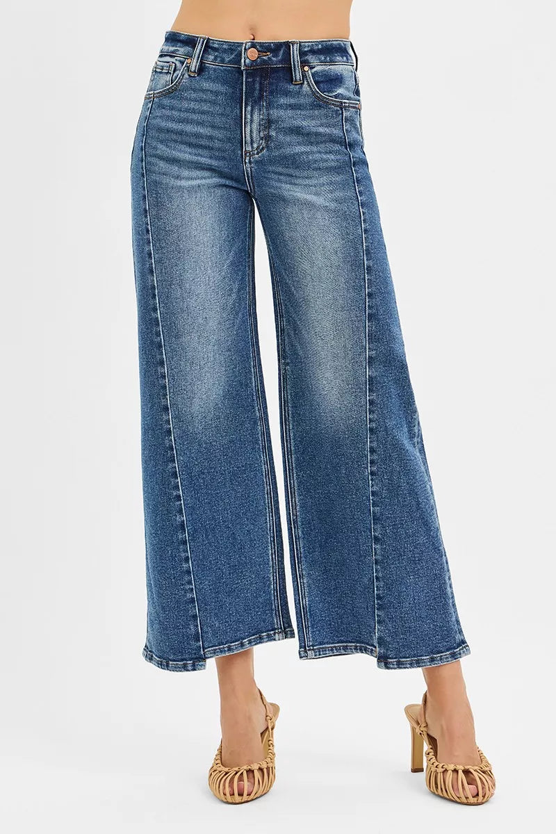 Blue jeans worn by a person on a white background