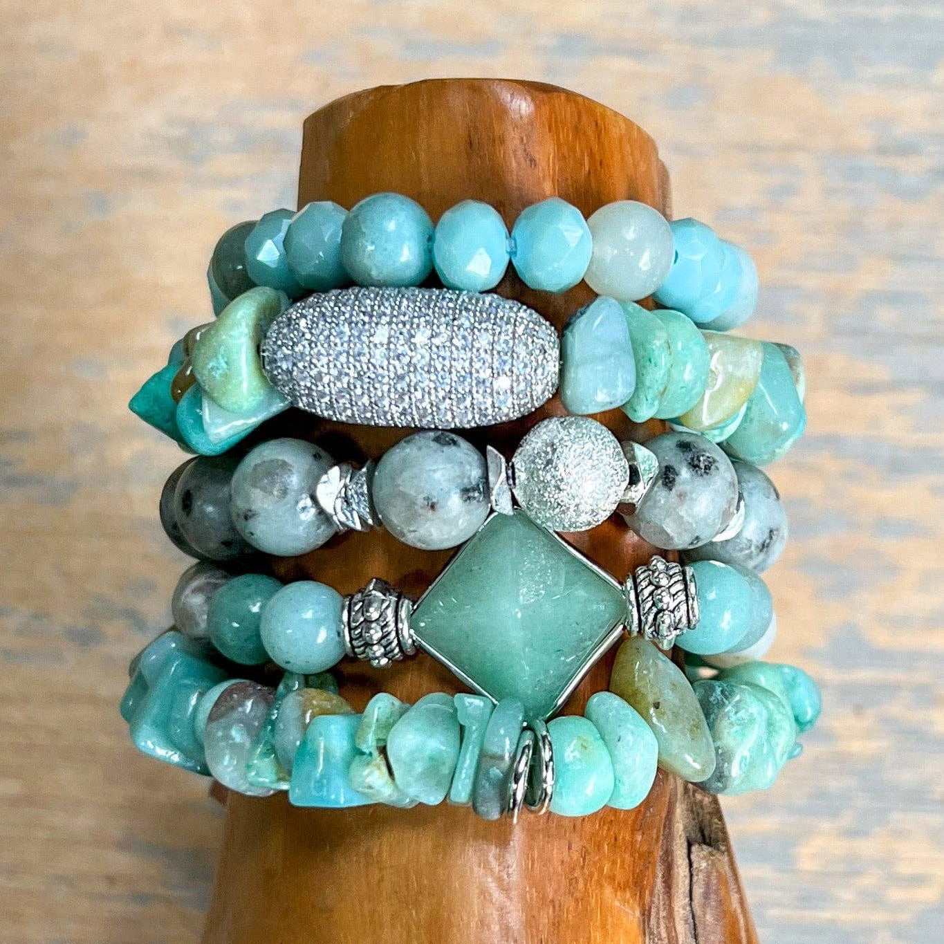 Stack of turquoise beaded bracelets on a wooden surface