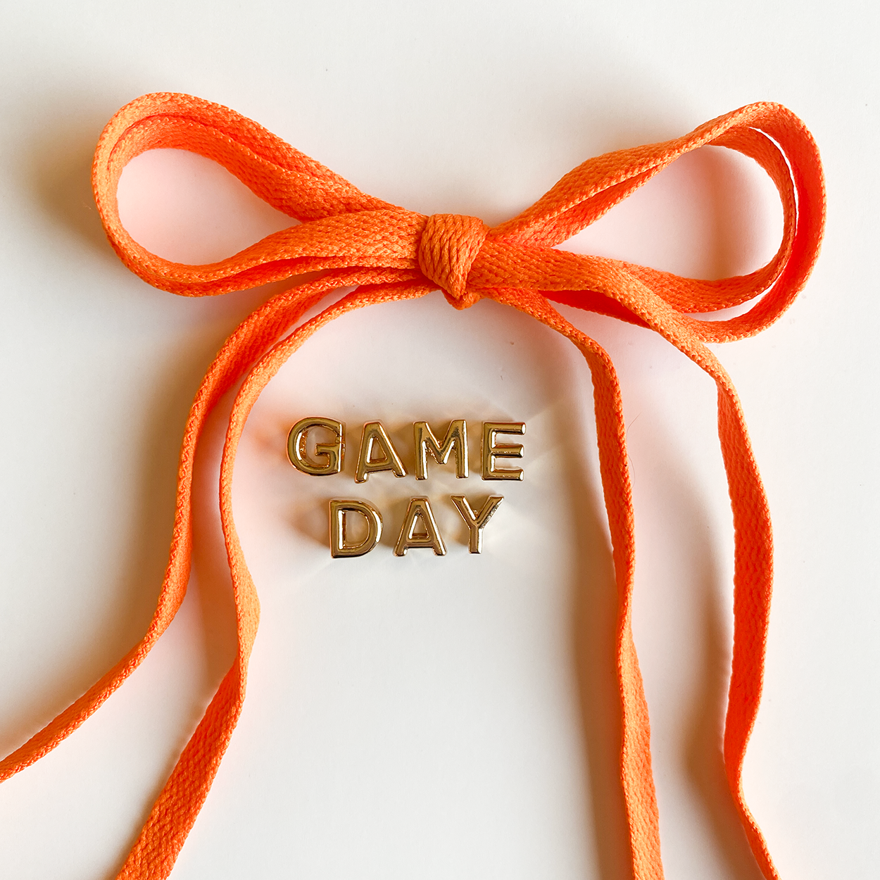 Orange ribbon with 'GAME DAY' text on a white background