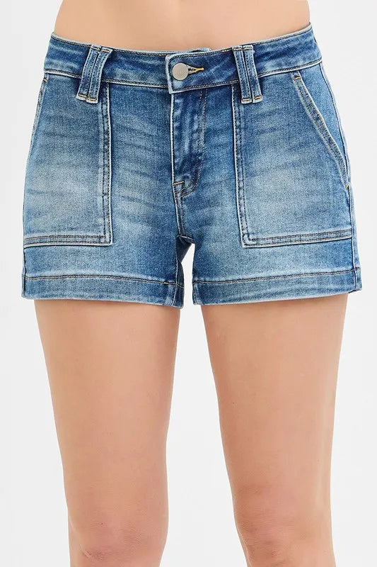 Blue denim shorts on a plain background