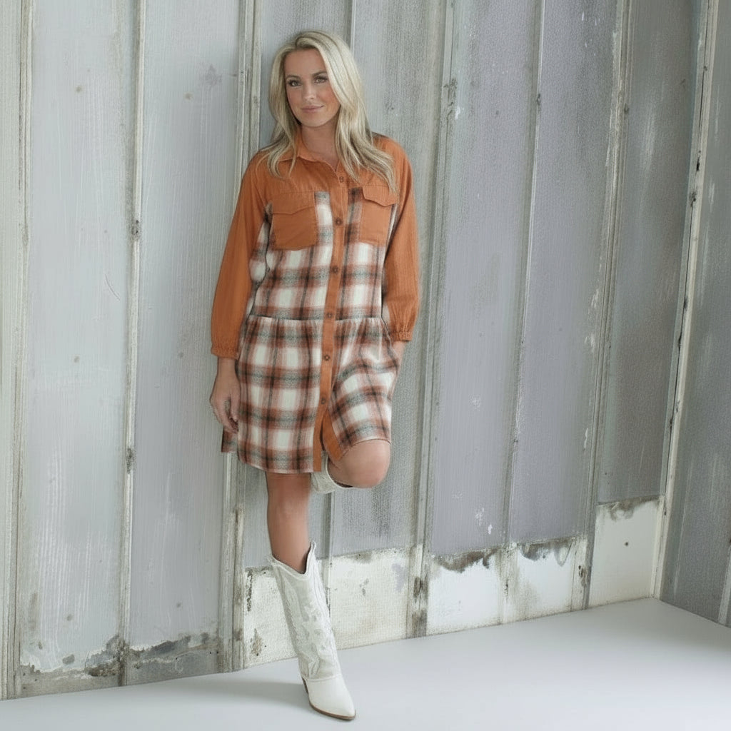 Person standing on a set of outdoor stairs with a textured wall and floor.